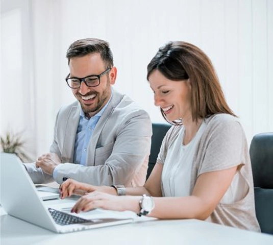Couple sitting in front of computer Preparing to buy a home